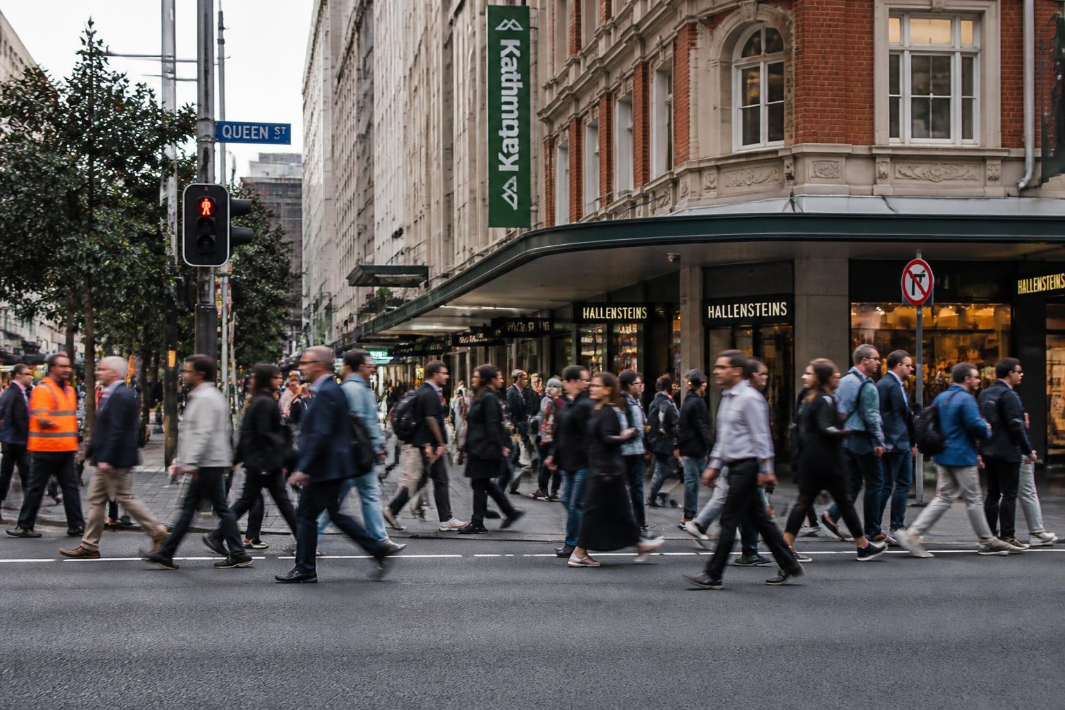 Ordinary New Zealanders crossing an Auckland street — ACC covers everyone, regardless of fault.